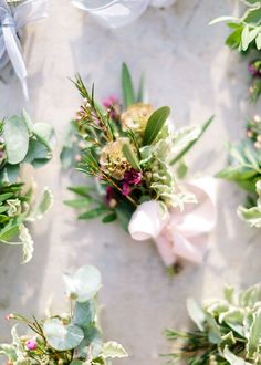 flowers and greenery laid out on the ground