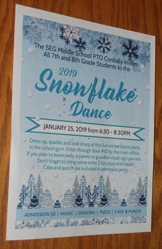 the flyer for snowflake dance is displayed on a wooden table with white and blue decorations