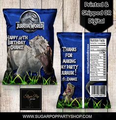 two bags of dinosaur birthday cake next to each other on a wooden background with the label printed and shipped or digital