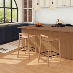 two stools are in front of the kitchen island