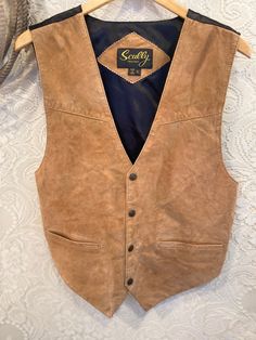 "Tan Suede Sully Pearl Snap Vest men's size S women's size M/L. Great suede vest for a man or woman. No major flaws and I will steam and clean before shipping. Vintage and handmade items will not be perfect but I try to capture any flaws in photos Tag: Scully men's S, women's M/L Shoulder to Shoulder: 15\" Bust: 19\" Waist: 18\" adjustable back strap Length 25\"" Rugged Fitted Vest Outerwear, Fitted Sleeveless Rugged Outerwear, Studs And Spikes, Suede Vest, Tony Lama, Vests Mens, Leather Vest, Working Late, Tan Suede