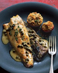 a blue plate topped with fish and potatoes