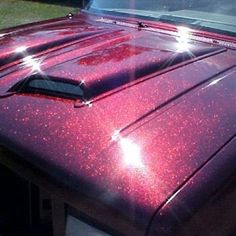 the hood of a red truck with lights on it