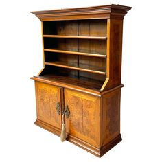 an old wooden bookcase with two doors on one side and a drawer on the other