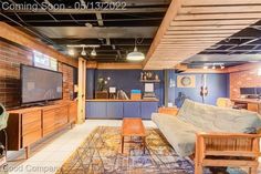 a living room filled with furniture and a flat screen tv on top of a wooden entertainment center