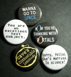 four badges with words on them sitting next to each other in front of a black background