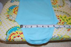 a blue cloth diaper with a measuring tape on it