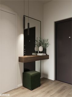 a mirror sitting on top of a wooden table next to a green stool and potted plant