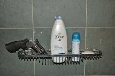 a hair dryer, comb and lotion sitting on a shelf in a bathroom