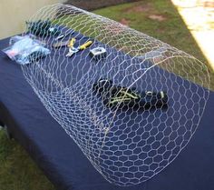 a blue table topped with lots of items on top of a purple cloth covered table