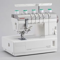 the janome sewing machine is white and has four needles on each threading needle