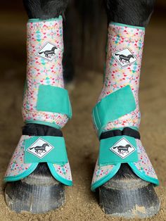 the legs and feet of a horse wearing boots with colorful sprinkles on them