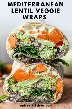 two wraps filled with veggies on top of a wooden cutting board and text overlay that reads mediterranean lentil veggie wraps