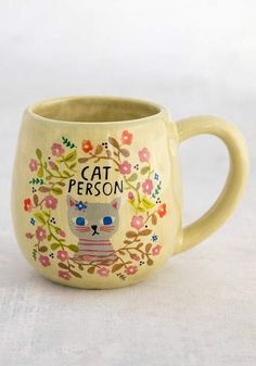 a ceramic mug with a cat on it