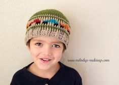 a young boy wearing a knitted hat