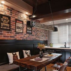 a dining room table and chairs with lights hanging from the ceiling