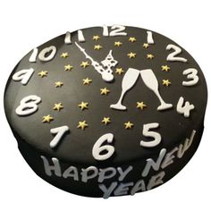 a black and white cake with gold stars on it's side that says happy new year