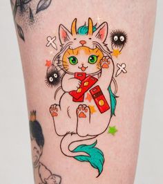 a close up of a person's leg with tattoos on it and an image of a cat