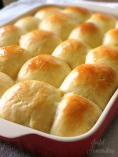 a red and white dish filled with rolls