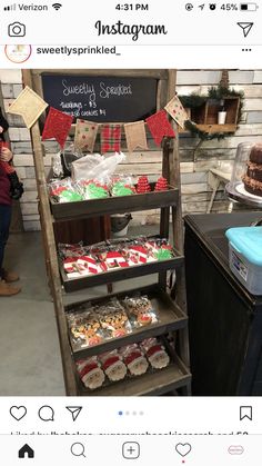 an assortment of baked goods on display in a store with a chalkboard sign above it