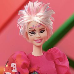 a close up of a doll with pink hair and eyeliners on her face