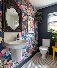 the bathroom is decorated with colorful wallpaper