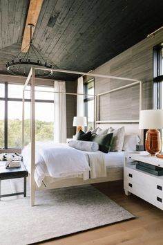 a bed room with a neatly made bed next to a window