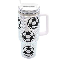 thermos cup has three soccer balls on it and is white with black dots