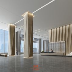 an empty lobby with two tall pillars in the center