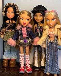 three dolls are standing next to each other