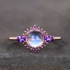 This is a Vintage Engagement ring set with natural Moonstone and Amethyst. This ring is marked S925/G10K/G14K Main stone is 7mm Round Cut Moonstone, side stones are Amethyst. Best Gift for Engagement,wedding,birthday gift. I accept custom making order.Please contact me if you need this service. All the jewelry in my store is handmade.It may take 3-4 weeks to finish. For all the jewelries,there is a 14 days money back guarantee.You can return it in the time frame without any questions.However the White Amethyst Ring For Anniversary, Purple Moonstone Ring For Anniversary, Purple Moonstone Gemstone Ring For Anniversary, Purple Moonstone Round Jewelry, Rose Gold Amethyst Ring With Accent Stones, Rose Gold Amethyst Ring With Gemstone, Rose Gold Round Amethyst Ring, Rose Gold Amethyst Gemstone Ring, Rose Gold Amethyst Crystal Ring