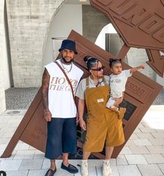 a man and woman standing in front of a sculpture