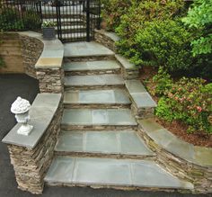 stone steps leading up to a fenced in area