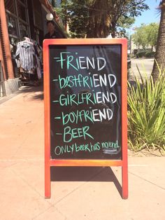 a chalkboard sign that says friend boyfriend girlfriend boyfriend beer only books this moment on the sidewalk