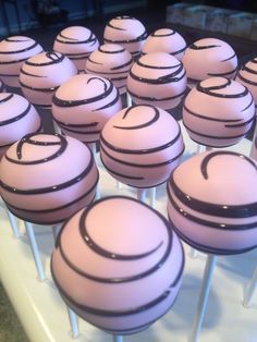 there are many pink cake pops with black lines on them in the shape of circles