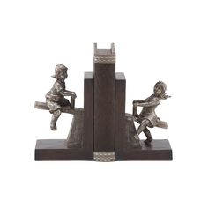 two bookends with metal figurines sitting on top of eachother