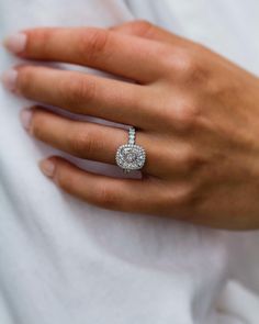 a woman's hand with a diamond ring on it