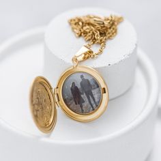 Oval Photo Locket Necklace - a timeless and cherished keepsake to hold your loved ones near. The Oval Photo Locket Necklace is the ideal gift for those who treasure their closest connections. Featuring an elegant oval-shaped locket, it securely holds a photo or memento of a dear one, allowing you to carry their presence close to your heart. This exceptional piece makes a thoughtful gift for any occasion, such as birthdays or anniversaries, and can be further personalized with engraving for added sentiment. The Oval Photo Locket Necklace is a distinguished and sentimental addition to any jewelry collection, embracing its timeless design and inherent emotional value. 💬 Please send us your image via direct messages. 📣 Additional information about the product 👉 Material: Stainless steel 👉 Vintage Necklace With Engraving Option For Keepsake, Anniversary Jewelry Locket In Medallion Shape, Valentine's Day Medallion Jewelry Gift, Anniversary Jewelry Locket Round Pendant, Anniversary Locket Pendant Jewelry, Anniversary Locket Round Pendant Jewelry, Valentine's Day Gift Locket Necklace With Round Pendant, Anniversary Pendant Locket Jewelry, Round Pendant Locket Jewelry For Anniversary