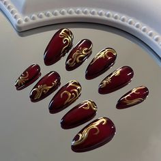 Shiny Burgundy Nails, Red Black And Gold Acrylic Nails, Red And Gold Flake Nails, Red Nails With Gold Details, Gold With Red Nails, Red And Gold Design Nails, Red And Gold Cat Eye Nails, Red And Black And Gold Nails, Red Nails Gold Design