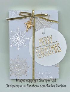 a white christmas card with gold foil on it and a tag that says merry christmas