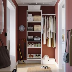 an open closet with clothes, shoes and bags on the shelves in front of it