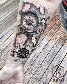 a man with a compass tattoo on his arm