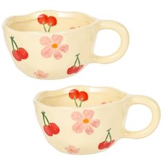 two white cups with cherries and flowers painted on the sides, one is empty