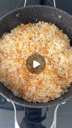 a frying pan filled with shredded cheese on top of a stove