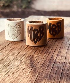 three rolls of toilet paper with the word hope written on them sitting on a wooden table