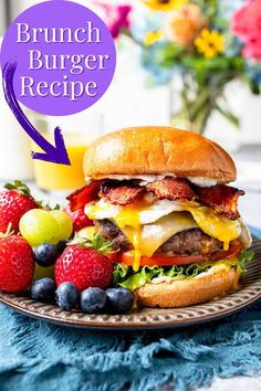 a burger on a plate with strawberries and blueberries next to it is the text brunch burger recipe