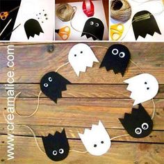 black and white paper bats hanging from string on wooden planks with eyes and noses