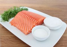 a white plate topped with salmon and yogurt