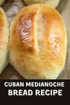 four bread rolls sitting on top of wax paper