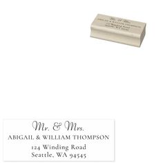 a rubber stamp with the words mr and mrs in black ink on it, sitting next to a white envelope